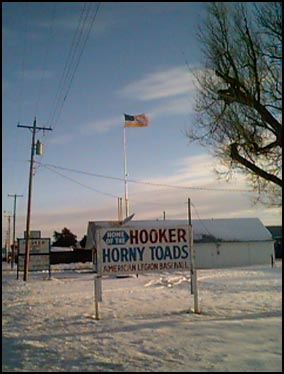 HOOKER, OK -  Not only is there snow on the ground, but a 40 mph wind (note the flag) rocked the van and covered the road with blowing snow.